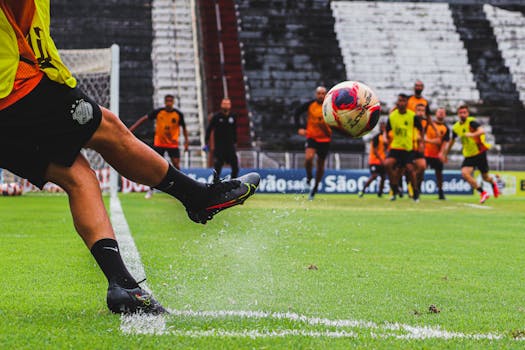 soccer players practicing free kicks