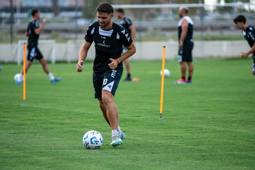 youth soccer players practicing dribbling