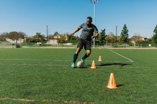 Soccer player doing cone dribbling drill